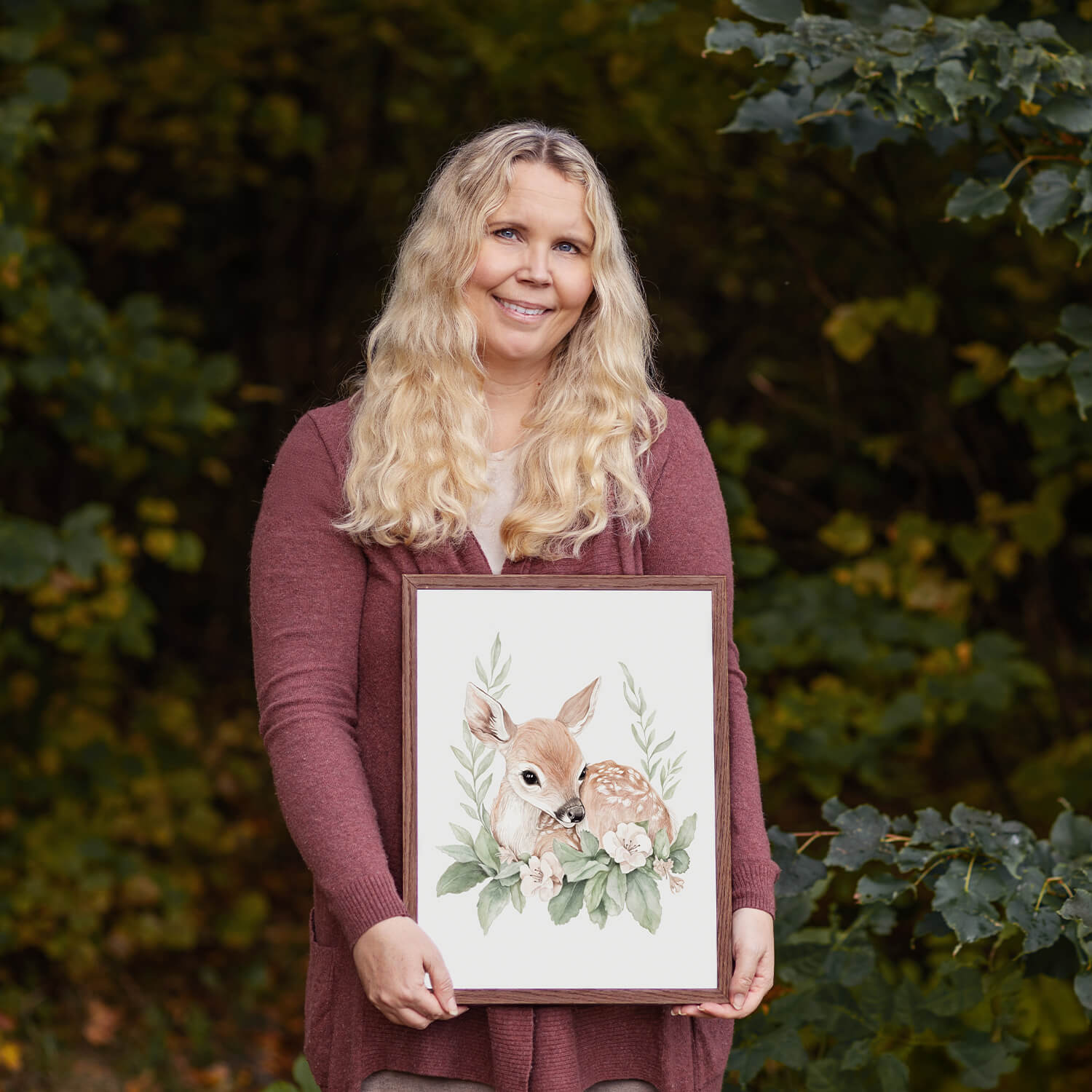 Illustrator Karolina Brunström with the Luna watercolor nursery poster in the forest