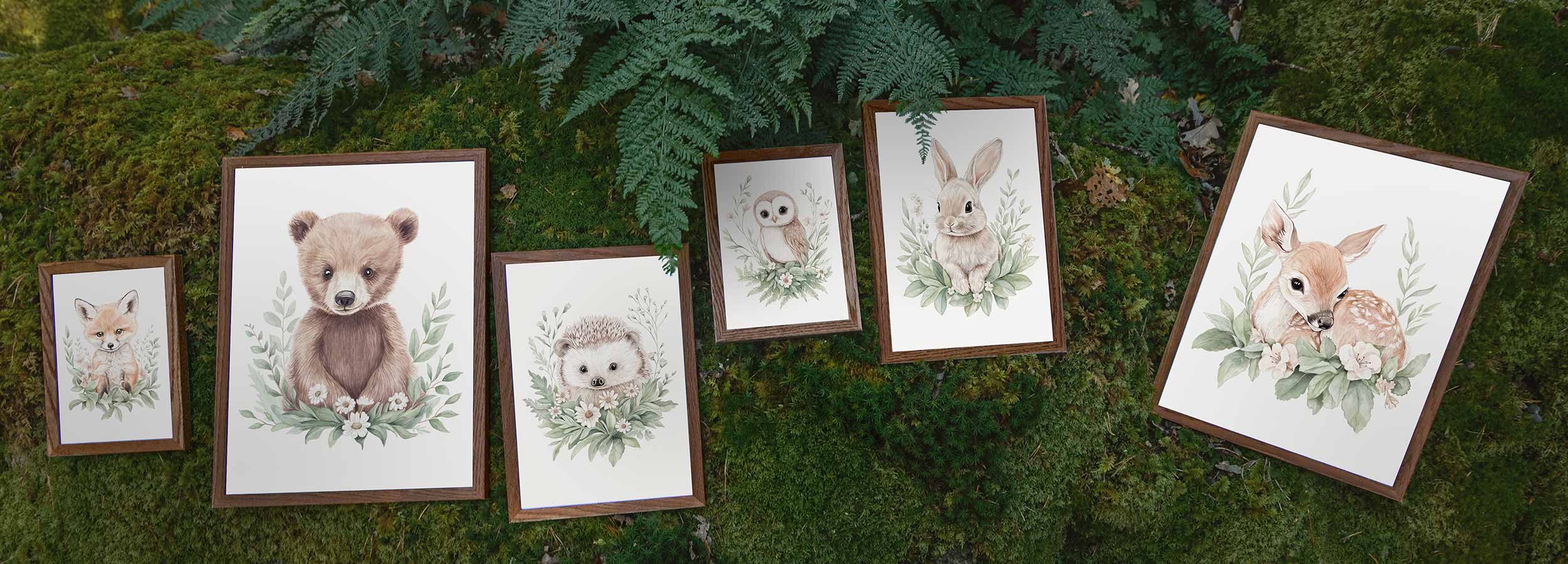 The Woodland Wonders collection of hand-painted watercolor posters for children, photographed in a natural woodland setting